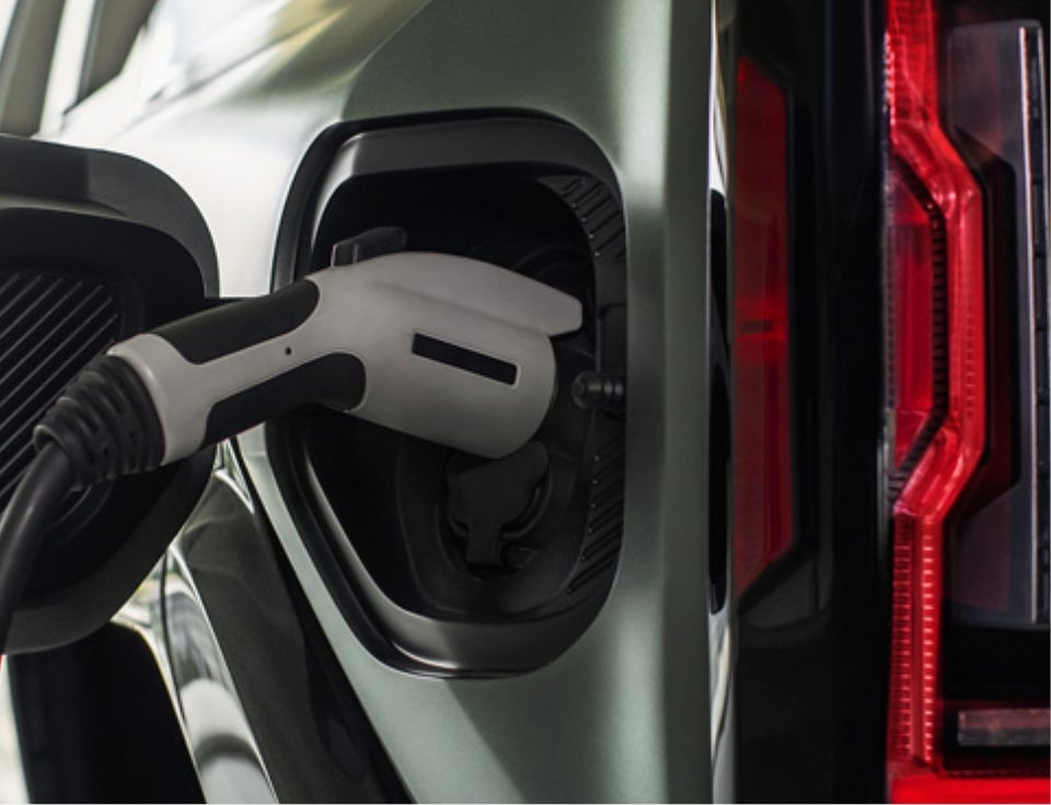 Close up of charging port with charger plugged in on a GMC Hummer EV SUV - Sandman Brothers in SHELBYVILLE IN